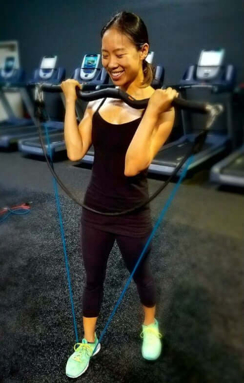 Woman exercising with extra light resistance bands in a gym setting