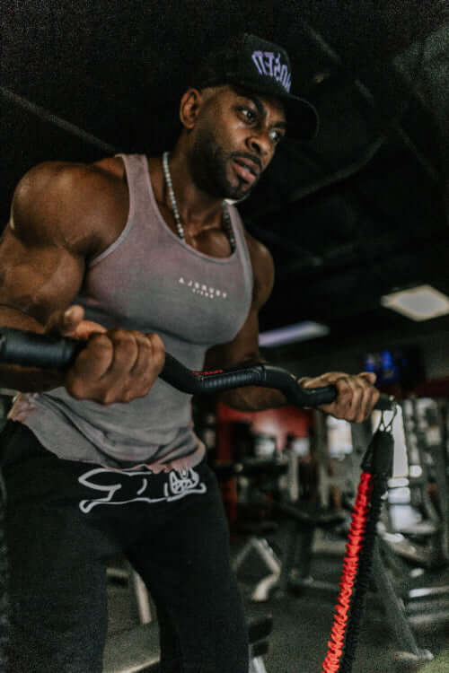 Man exercising with resistance bands in a gym setting