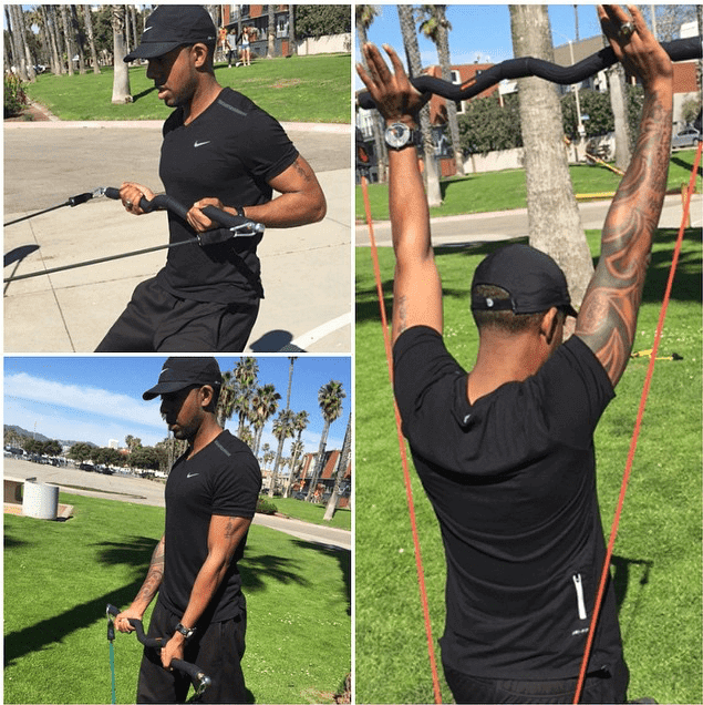 Man performing resistance exercises with bands to illustrate Traditional Weightlifting techniques outdoors.