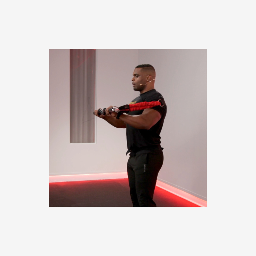 Person performing a chest press with resistance system 2.0 bands