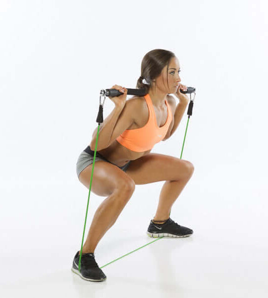 Woman performing Xbar squats exercise