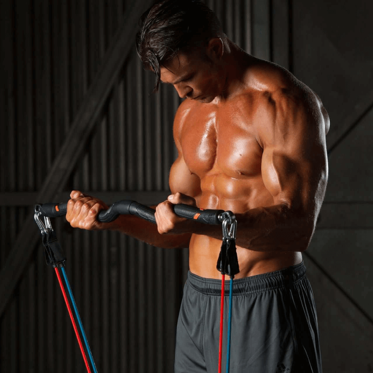 David Kimmerle, personal trainer, using resistance bands performing a bicep curl using an exercise curl bar and blue and red resistance bands against a dark background.