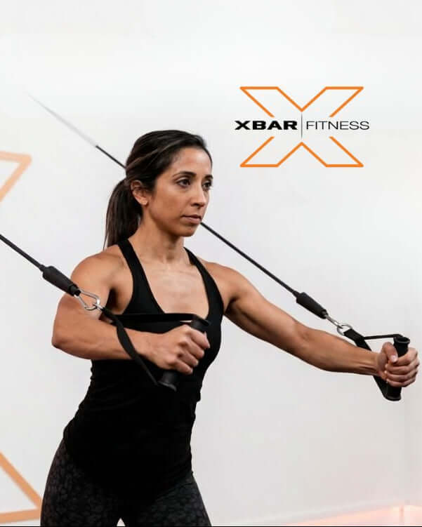 Woman exercising with XBar Fitness heavy duty handles with door anchor attachment against a white background