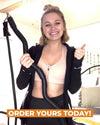 Woman showing xbar exercise bar with heavy resistance black band with 70lbs of tension in her bedroom to show you can workout and exercise anywhere.