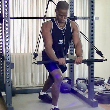 Man working out with resistance bands in a home gym, demonstrating strength training and fitness dedication.