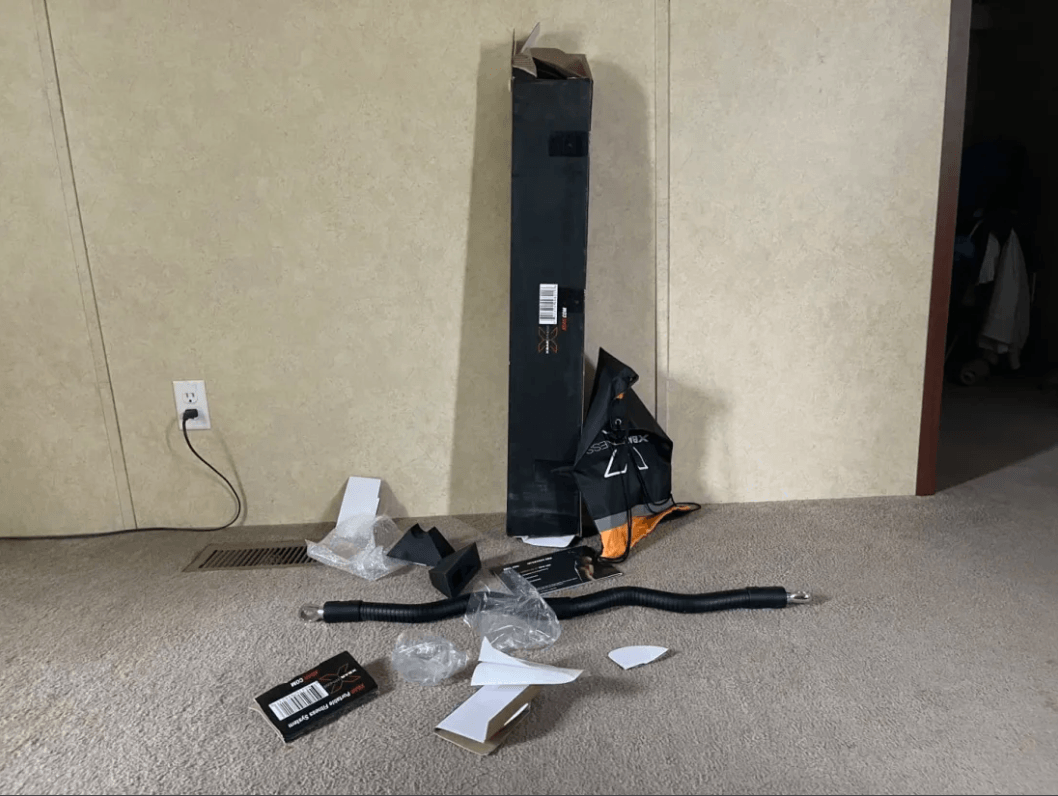 XBAR All in One Home Gym on a carpeted floor against a beige wall.